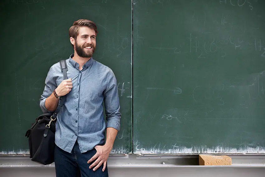 Bild junger Lehrer vor Schultafel